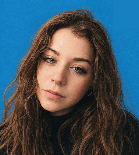 Portrait of Giada Pacchioni against a vivid blue background